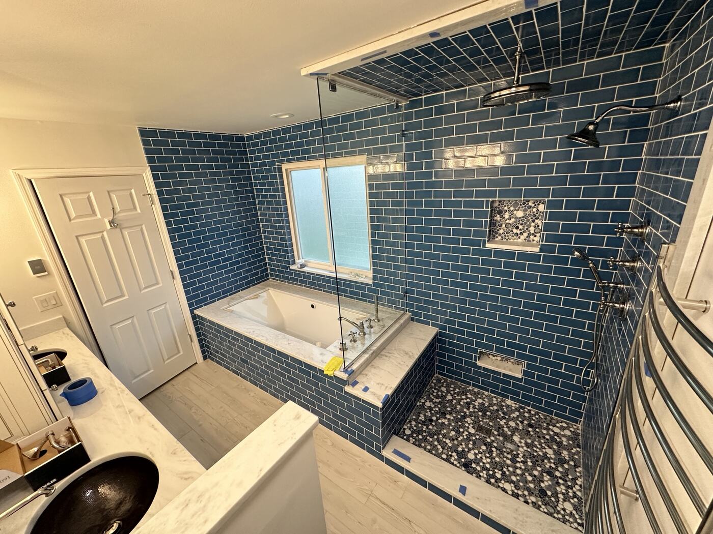 Completed blue subway-tile bathroom